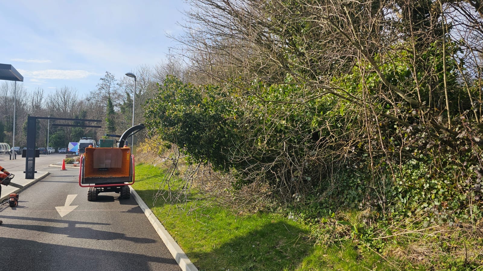 Professional tracked wood chipper positioned at the Starbucks drive-through near Asda Clayton Brook during a storm-damaged tree removal project.